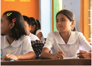 Aiza Magarin, 11 years old and Pantawid Pamilya beneficiary attentively listens to the questions of her teacher during a quiz in her grade six Mathematics class at Butuan City West Central Elementary School.