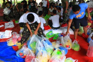 The volunteers pack relief goods in the Relief Operation Center in Surigao City to be transported in Leyte.