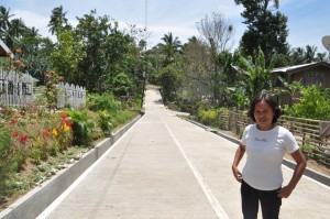 Cardena, BSPMC of Binga, Mainit, SdN, stands on the concreted road, a project intiated by Kalahi-CIDSS in their community