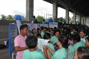 NHTS-PR Regional Focal Person, Dante S. Rosales (in pink shirt) spearheads the distribution of flyers and Regional Profile of the Poor to the participants.
