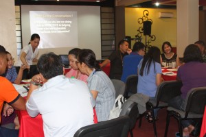 Representatives from the different national govenrment agencies assess the disastrer response experience employing the Meaningful Conversations via World Cafe facilitated by Ms. Glezza T. Ty, (in white blouse) DSWD FO Caraga Regional Training Specialist