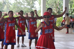 Red Team gleefully presents their chant with Ms. Catalina Jomocan, RRCY Head as their cheer leader