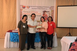 DSWD Caraga Regional Director Minda B. Brigoli hands - over the check worth 1.4 million to the Sibog Katawhan alang sa Paglambo Inc. (SIKAP) Chairman, Mr. Gil C. Gilot. The first tranche check turn – over is for the operational cost of Modified Conditional Cash Transfer for Indigenous People (MCCT IP) program implementation for August to December 2014 engagement covering four provinces of Caraga namely: Surigao Del Norte, Surigao del Sur, Agusan del Norte, and Agusan del Sur.  (Left to right) NPMO IP Focal Ms. Jeanira G. Okubo, SIKAP Chairman Mr. Gil C. Gilot, RD Minda B. Brigoli, and SIKAP Executive Director Ms. Christine H. Ampon)  