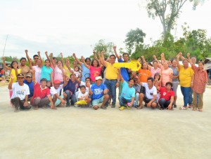GRATIFYING MOMENT. The happy members of Manyayay PAMANA People Association stand up on their long-awaited solar dryer. 