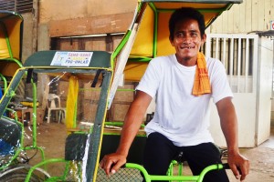 Jonathan B. Cayacot, association president of Pantawid Hinatuan SLP Association, with his cheerful face after receiving his traysikad.  