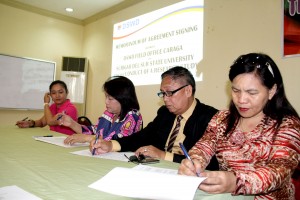 Regional Director Minda B. Brigoli (in violet with pink) and Dr. Baceledes R. Estal (in suit) signed the Memorandum of Agreement for the conduct of the research study.